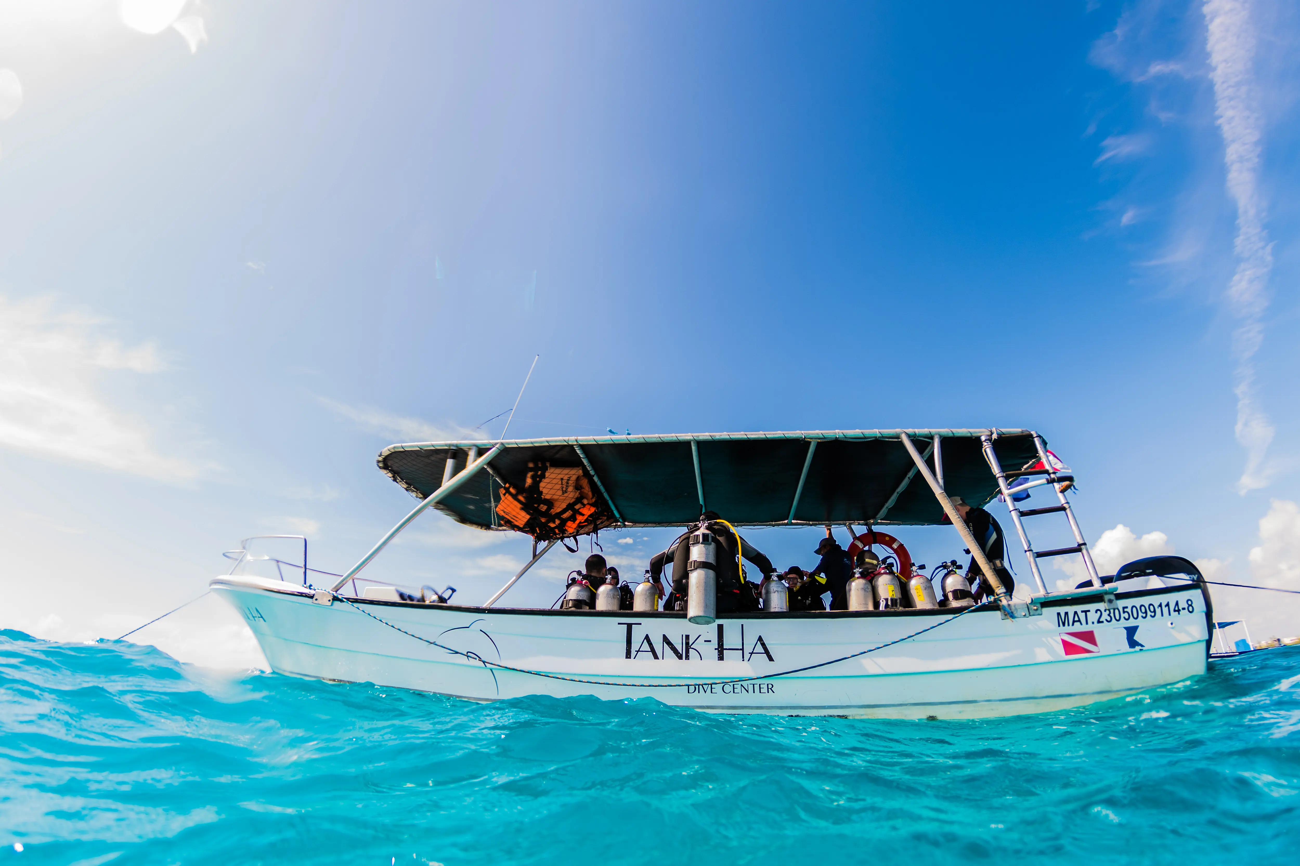Divers prepare to roll back from the boat